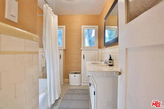 a bathroom with a sink and a mirror