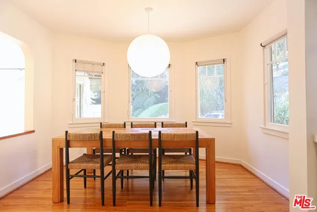a view of a dining room with furniture and wooden floor