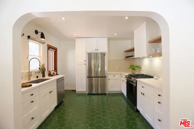 a kitchen with a sink stove and refrigerator
