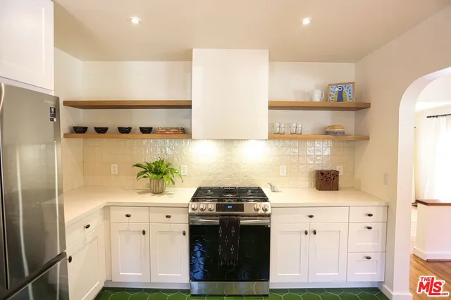 a kitchen with a stove and a refrigerator