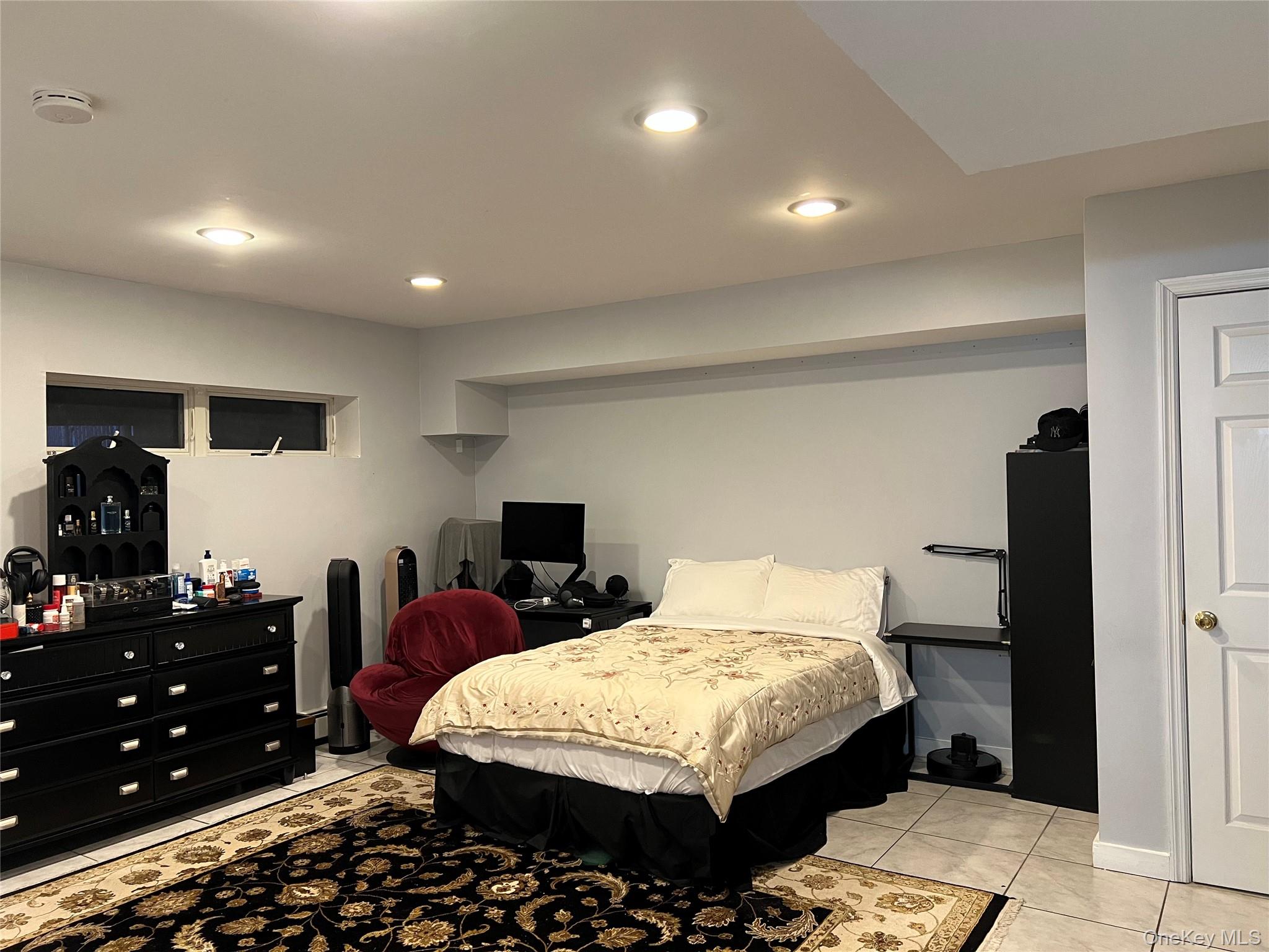 204 Outlook Avenue Bronx, NY 10465 - Photo 11 of 12 a bedroom with a bed and a furniture