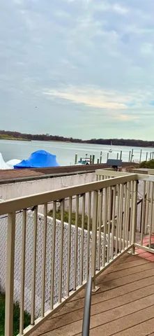 a balcony with wooden floor and city view