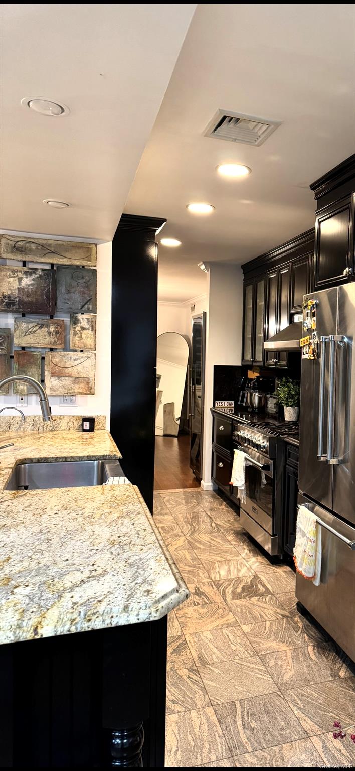 204 Outlook Avenue Bronx, NY 10465 - Photo 6 of 12 a kitchen with stainless steel appliances kitchen island granite countertop a refrigerator and stove