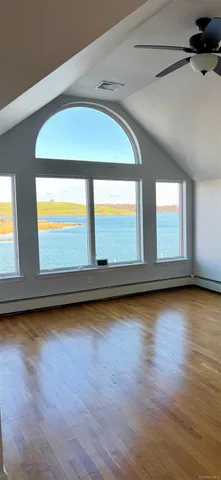 a view of wooden floor and windows in a room