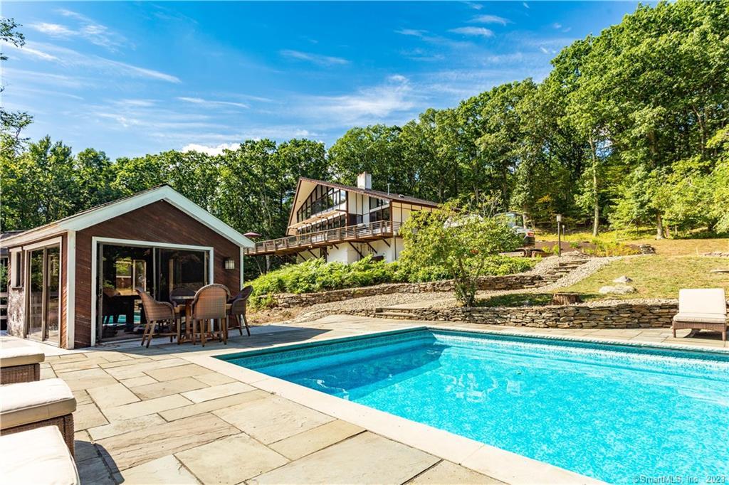 a view of a house with backyard patio and garden