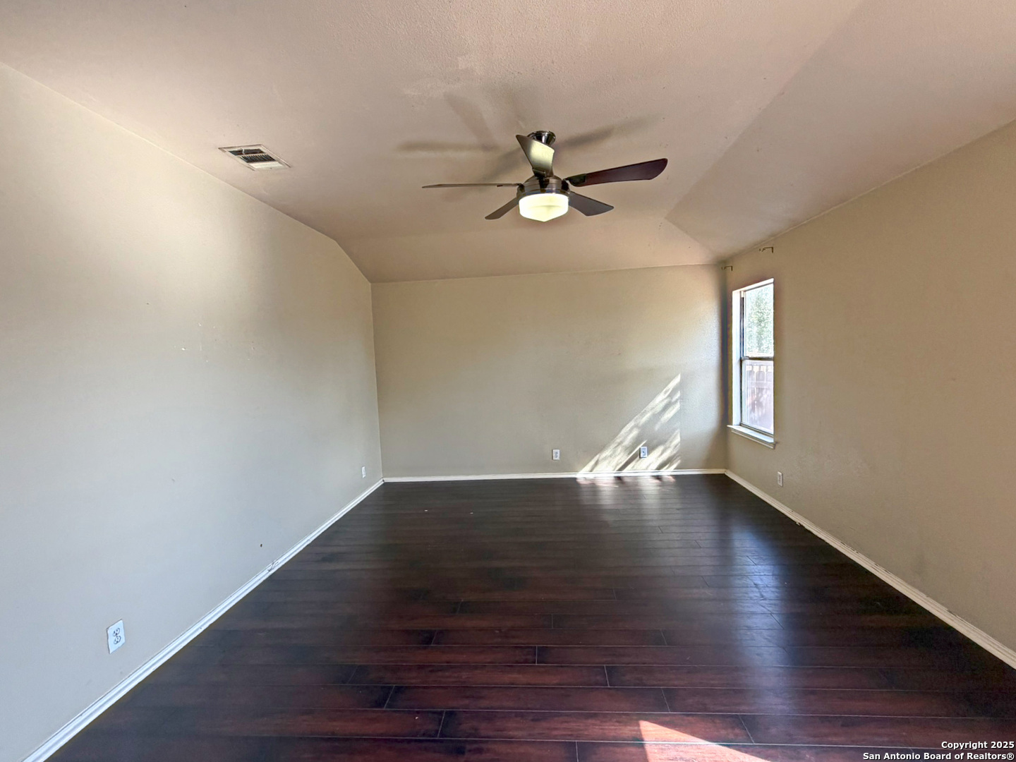 9626 Anderson Way Converse, TX 78109 - Photo 13 of 17 a view of an empty room with wooden floor and window