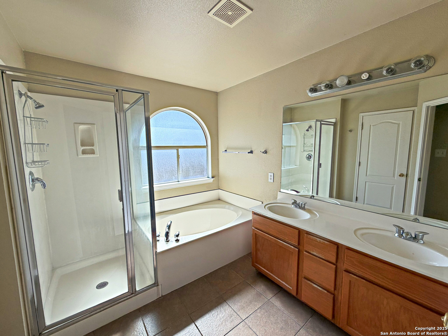 9626 Anderson Way Converse, TX 78109 - Photo 14 of 17 a spacious bathroom with a double vanity sink mirror and double