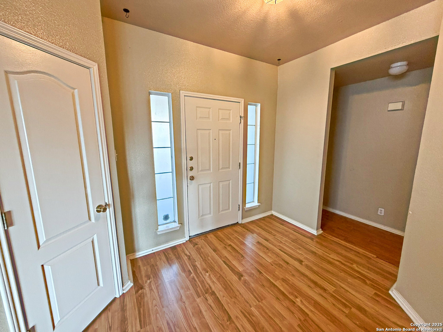 9626 Anderson Way Converse, TX 78109 - Photo 2 of 17 an empty room with wooden floor and entrance