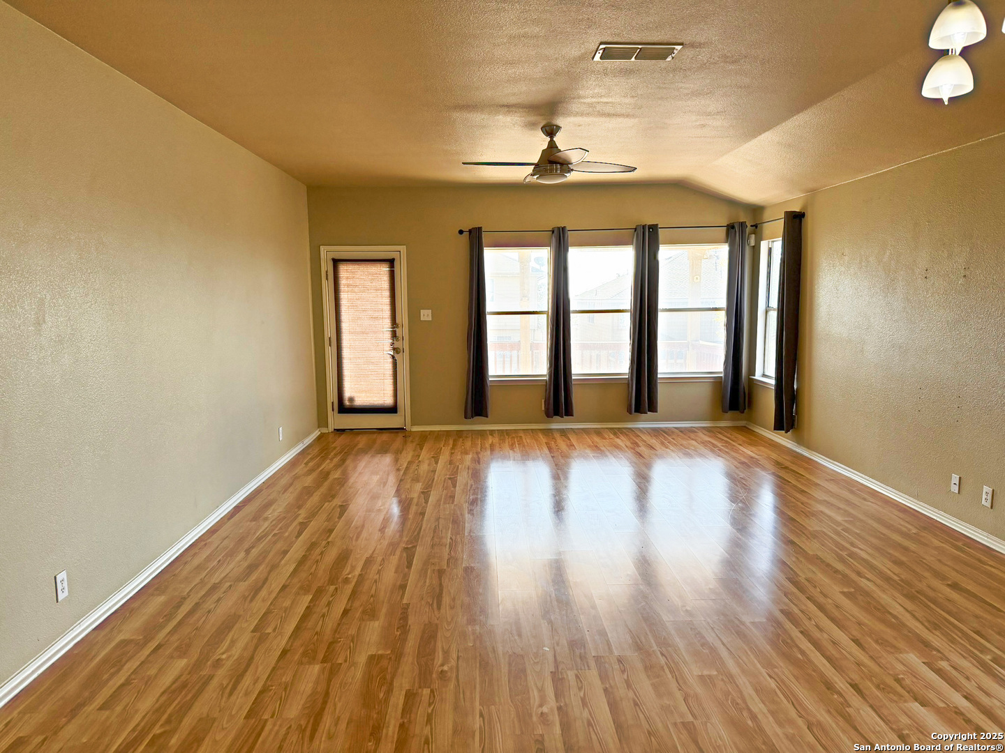 9626 Anderson Way Converse, TX 78109 - Photo 4 of 17 wooden floor in an empty room with a window