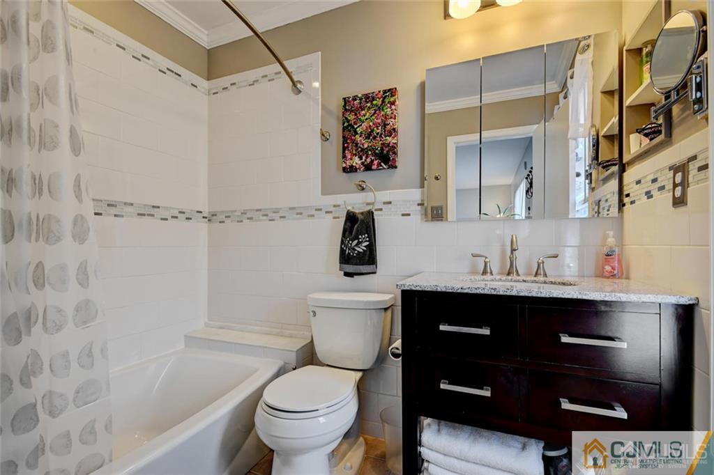 360 Constitution Circle North Brunswick, NJ 08902 - Photo 16 of 21 a bathroom with a sink a toilet and shower