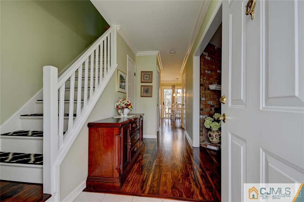 360 Constitution Circle North Brunswick, NJ 08902 - Photo 3 of 21 a view of a hallway with wooden floor and staircase