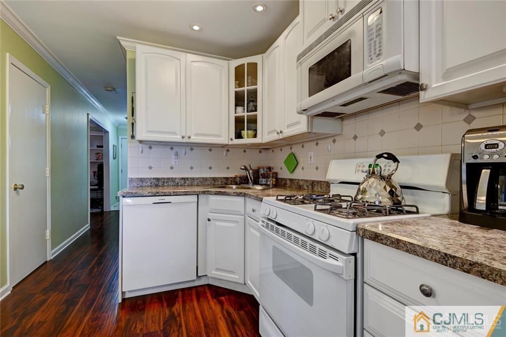 360 Constitution Circle North Brunswick, NJ 08902 - Photo 7 of 21 a kitchen with stainless steel appliances granite countertop a sink and a stove