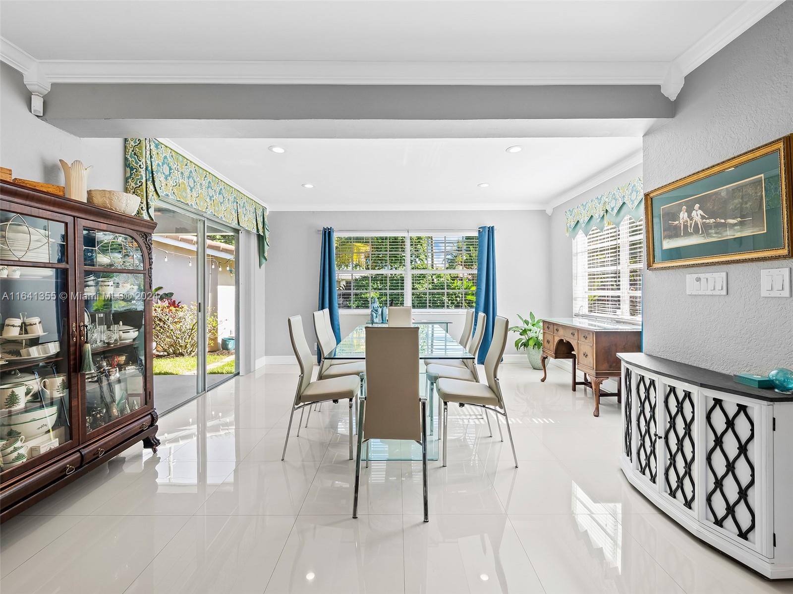 3904 Arthur Street Hollywood, FL 33021 - Photo 11 of 32 a dining room with furniture and a floor to ceiling window