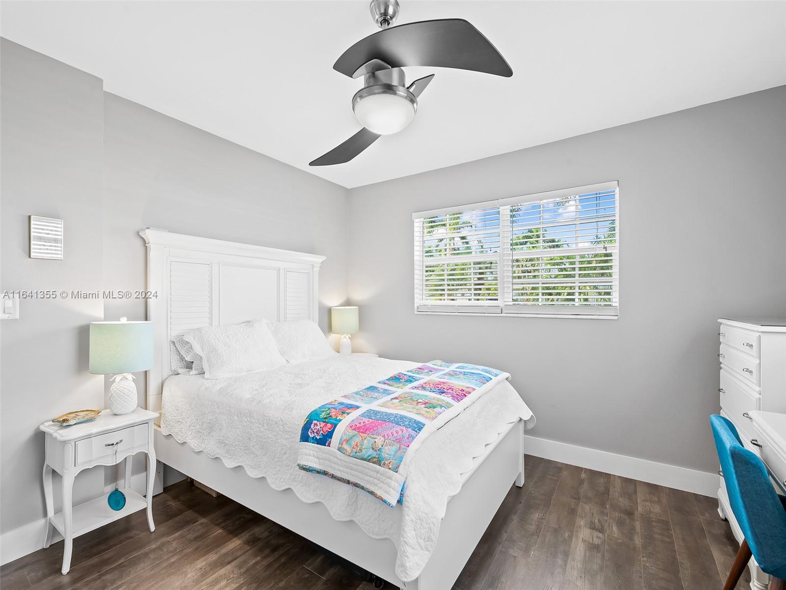 3904 Arthur Street Hollywood, FL 33021 - Photo 18 of 32 a bedroom with a bed and wooden floor