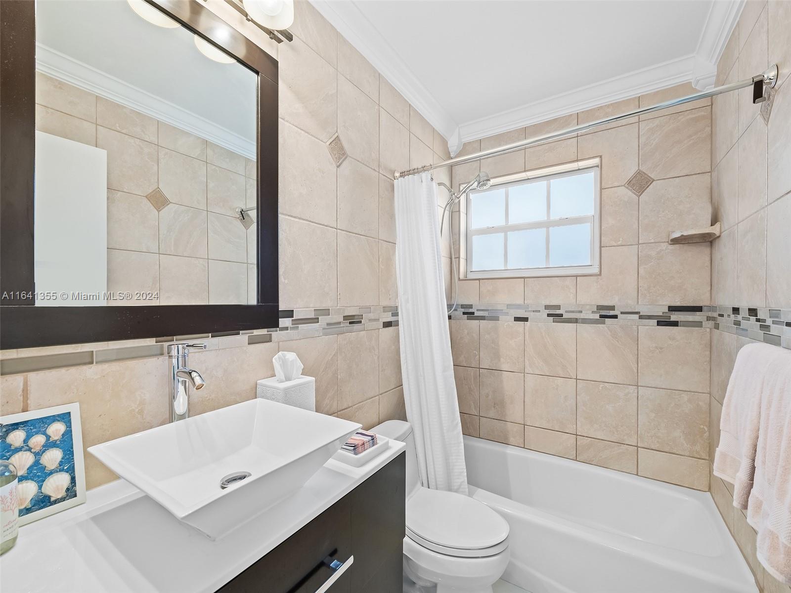 3904 Arthur Street Hollywood, FL 33021 - Photo 19 of 32 a bathroom with a sink a toilet a mirror and shower