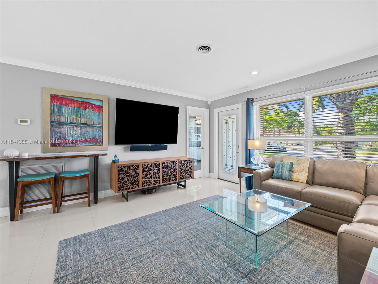 3904 Arthur Street Hollywood, FL 33021 - Photo 6 of 32 a living room with furniture and a flat screen tv