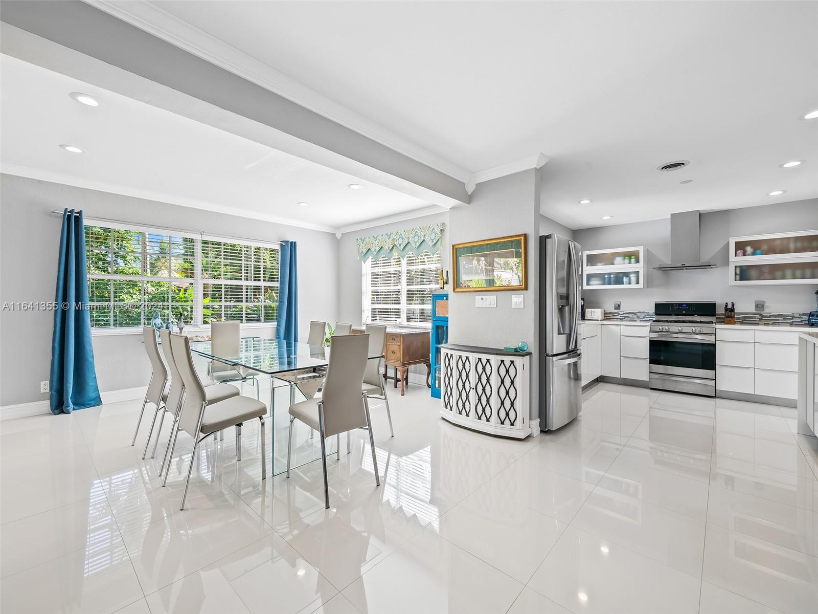 3904 Arthur Street Hollywood, FL 33021 - Photo 8 of 32 a view of a dining room and livingroom with furniture wooden floor and a rug