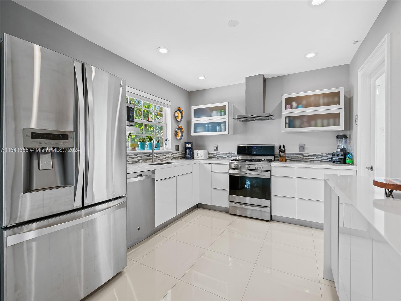 3904 Arthur Street Hollywood, FL 33021 - Photo 9 of 32 a kitchen with granite countertop white cabinets and white stainless steel appliances