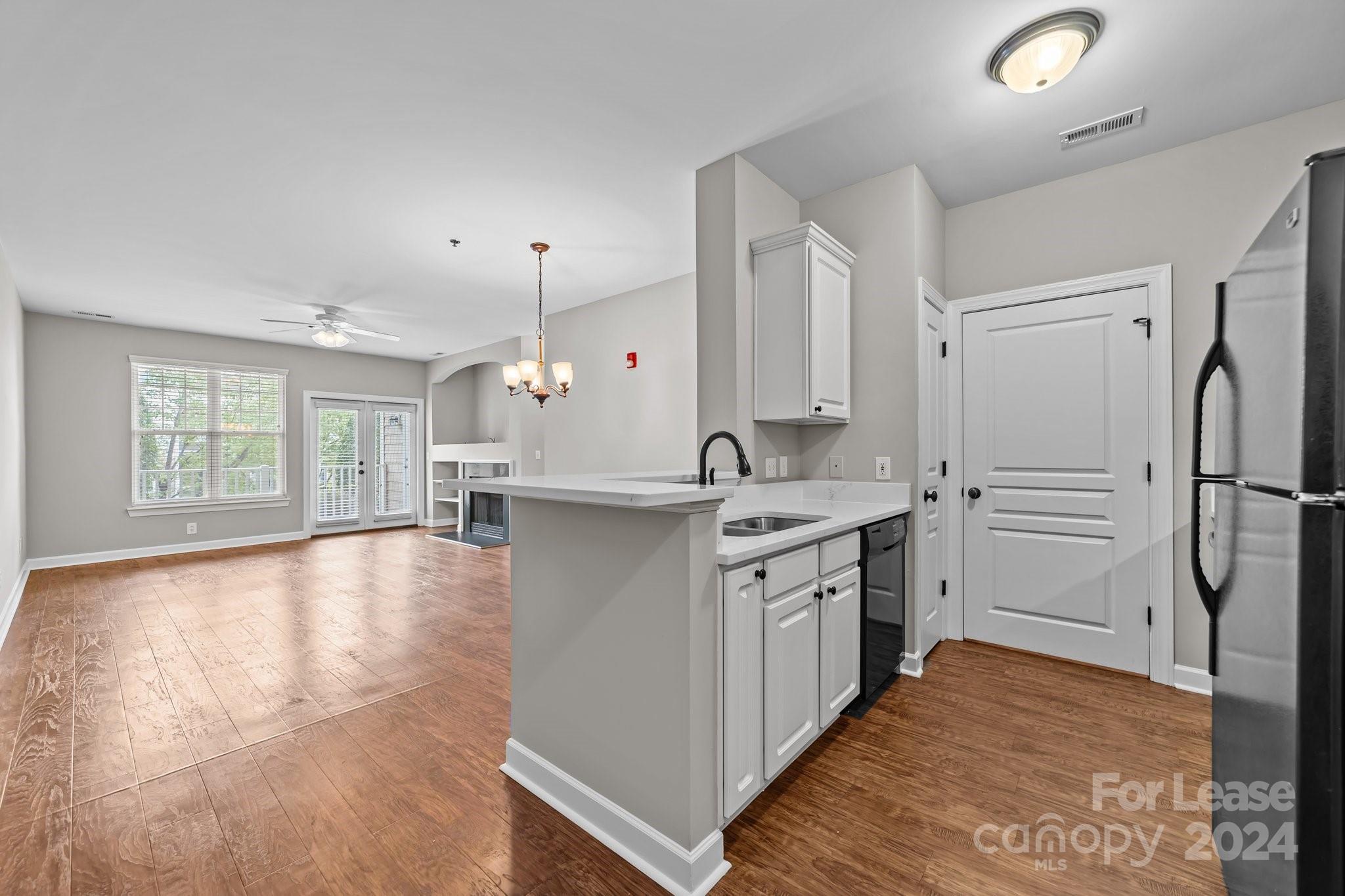 18605 Ruffner Drive, Unit 1C Cornelius, NC 28031 - Photo 11 of 27 a kitchen with stainless steel appliances a refrigerator sink and cabinets
