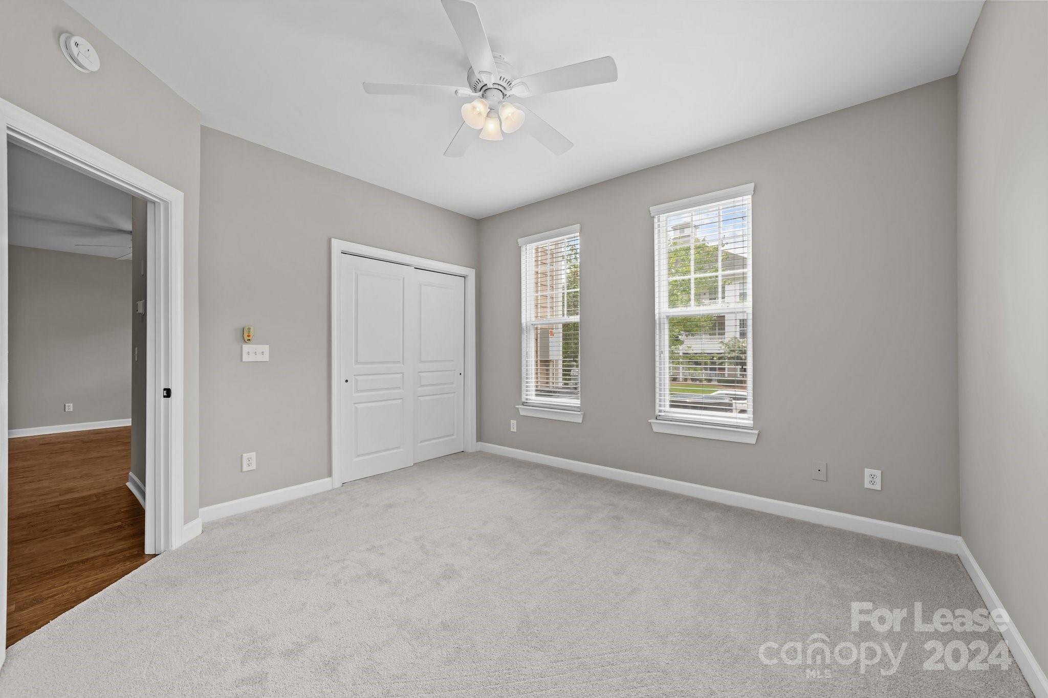 18605 Ruffner Drive, Unit 1C Cornelius, NC 28031 - Photo 17 of 27 an empty room with windows and fan