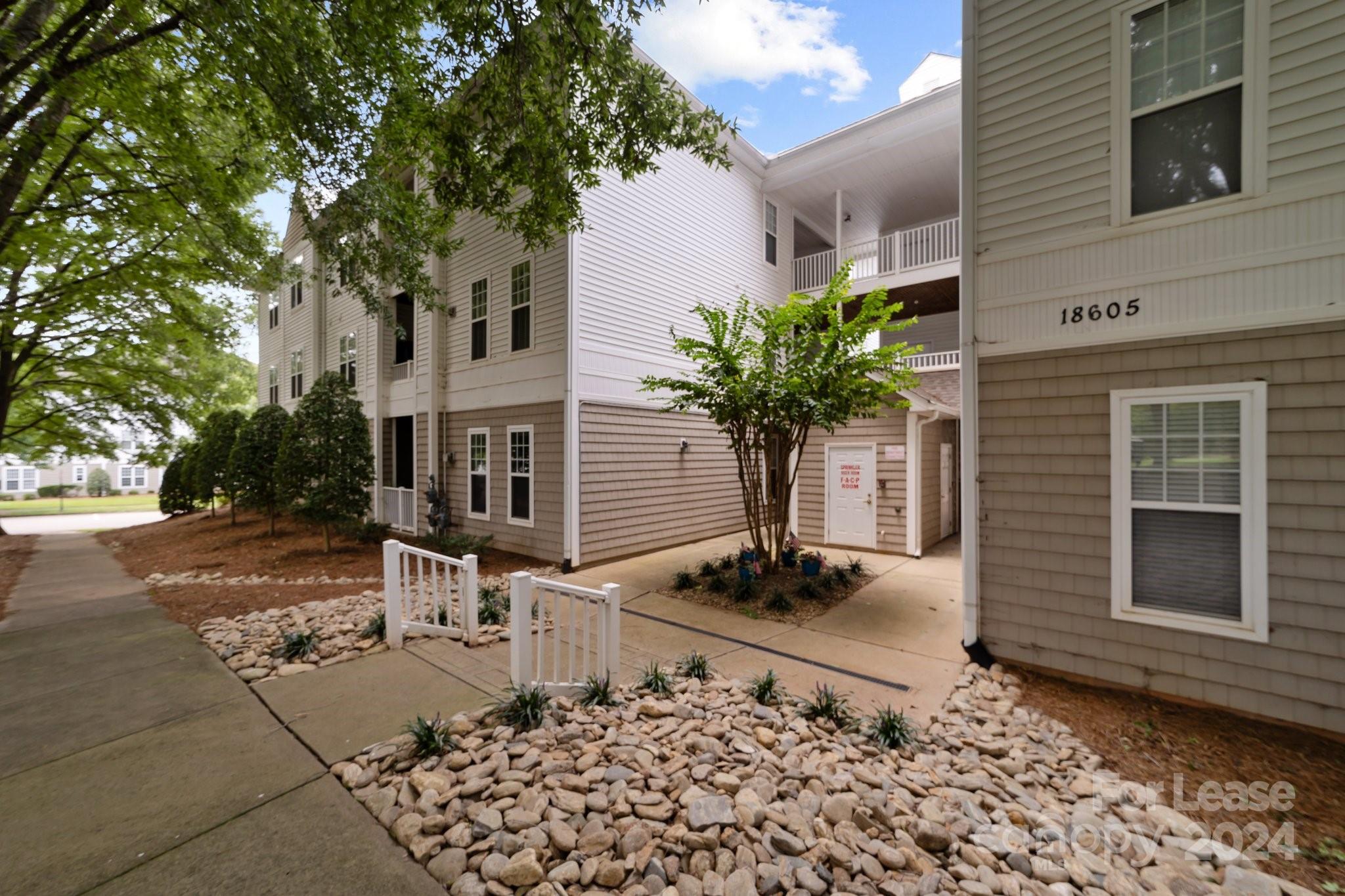 18605 Ruffner Drive, Unit 1C Cornelius, NC 28031 - Photo 20 of 27 a front view of a house with garden