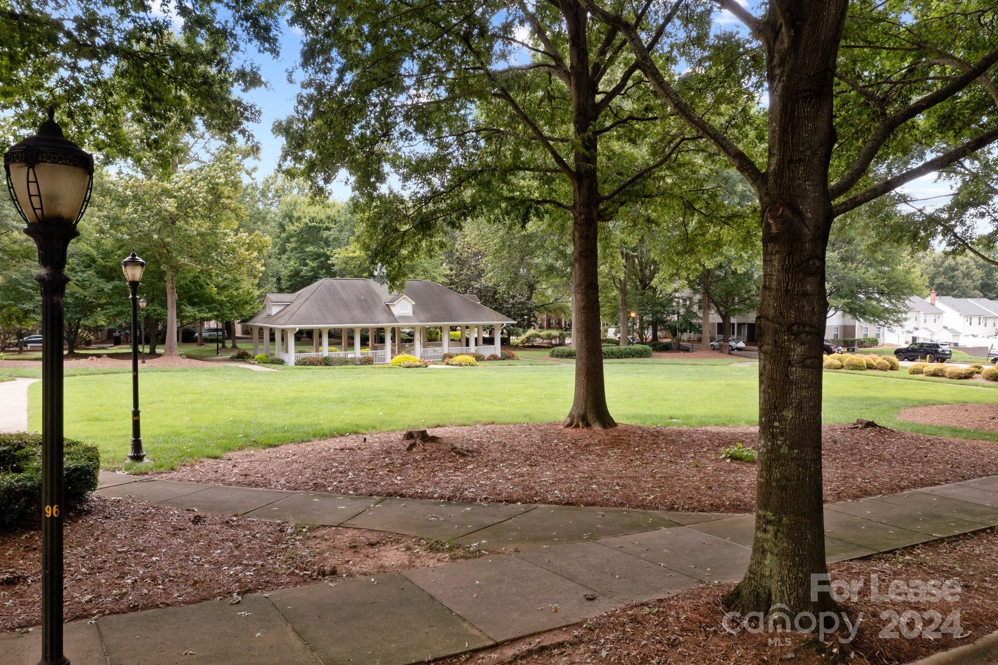 18605 Ruffner Drive, Unit 1C Cornelius, NC 28031 - Photo 22 of 27 a house with green field in front of it