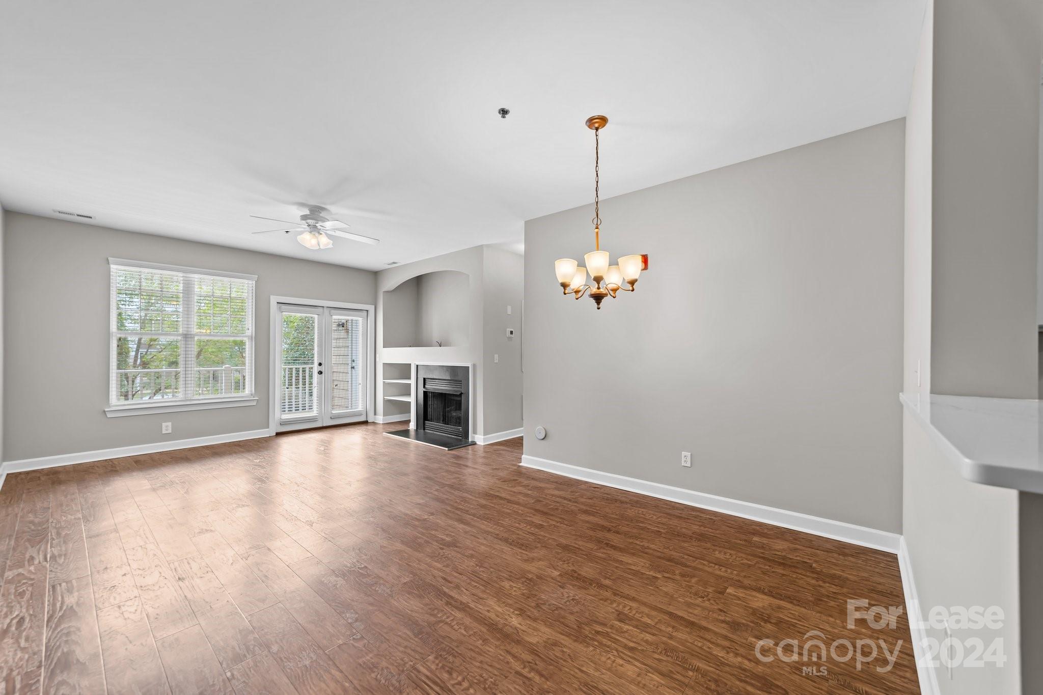 18605 Ruffner Drive, Unit 1C Cornelius, NC 28031 - Photo 4 of 27 a view of empty room with wooden floor and fireplace