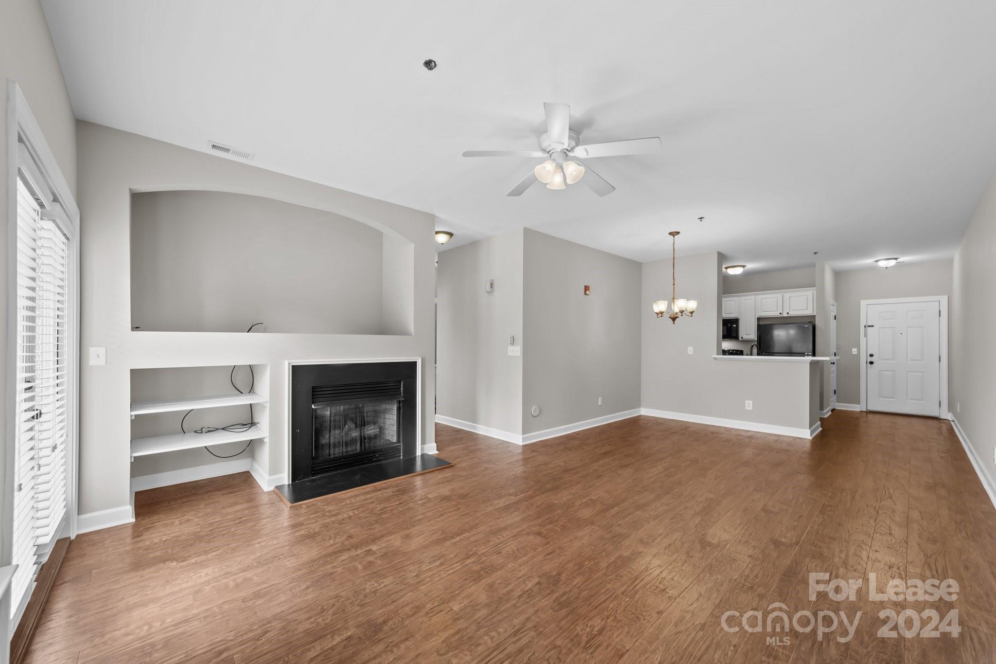 18605 Ruffner Drive, Unit 1C Cornelius, NC 28031 - Photo 6 of 27 a view of an empty room with a fireplace and a window