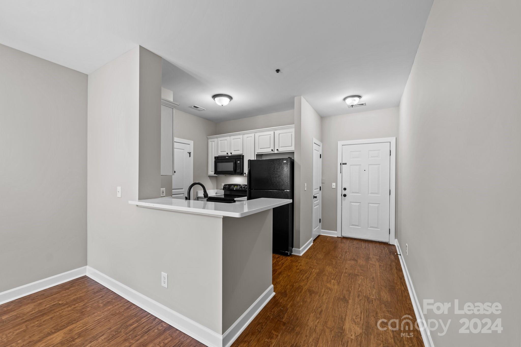 18605 Ruffner Drive, Unit 1C Cornelius, NC 28031 - Photo 7 of 27 a kitchen with a sink a counter top space and appliances