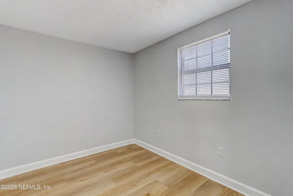 a view of hallway with wooden floor