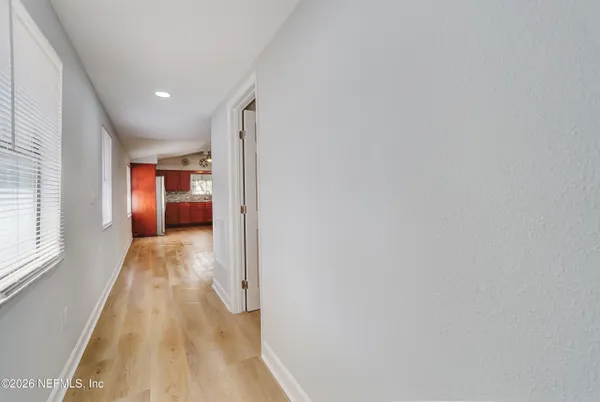 a kitchen with stainless steel appliances granite countertop wooden cabinets a sink and a counter space