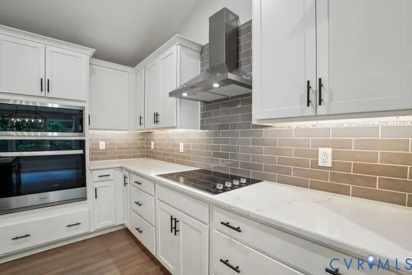 a kitchen with granite countertop a stove a sink and a microwave