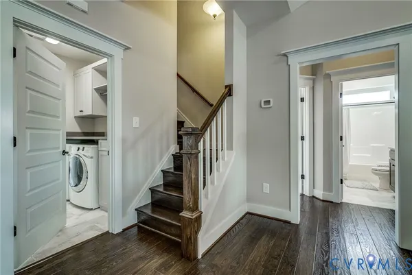a view of a hallway with wooden floor and entryway
