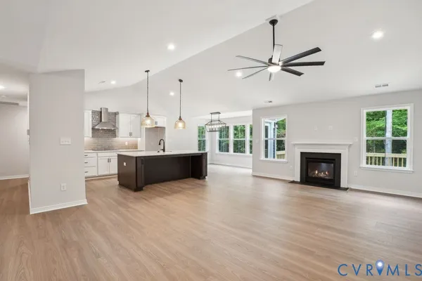 a view of a kitchen with a sink and a fireplace
