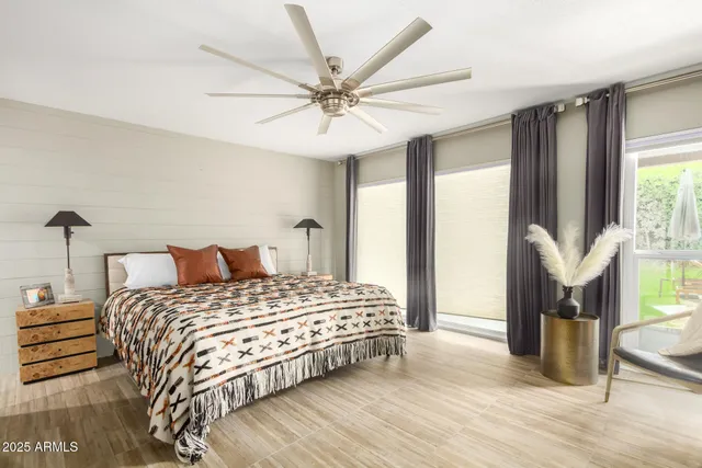 a bedroom with a bed and a chandelier