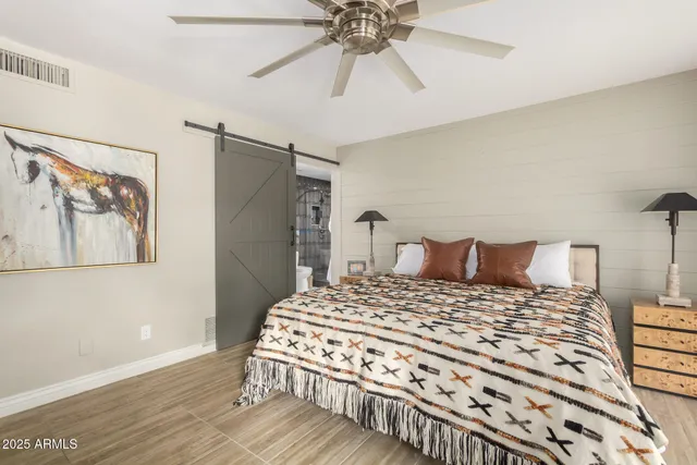 a bedroom with a bed and a chandelier