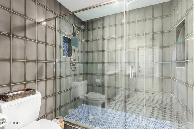 a bathroom with a toilet and shower