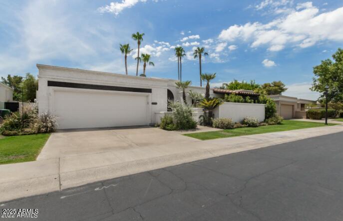2551 East Missouri Avenue Phoenix, AZ 85016 - Photo 2 of 25 a front view of a house with garden