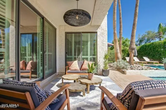a view of a patio with couches chairs and wooden floor