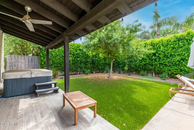 a backyard of a house with a garden and outdoor seating