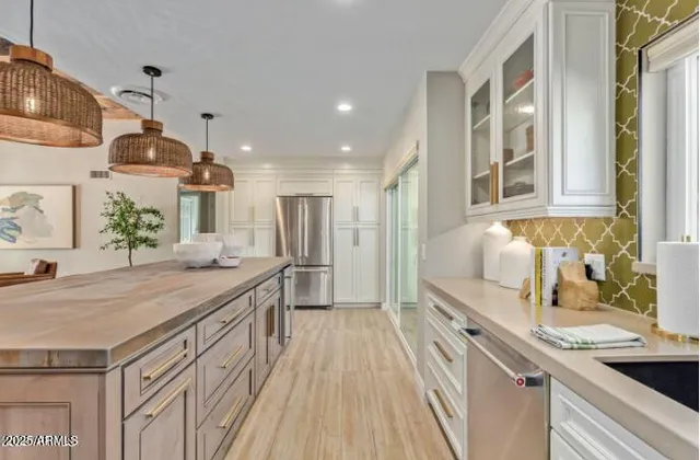 a kitchen with granite countertop a sink stove and refrigerator
