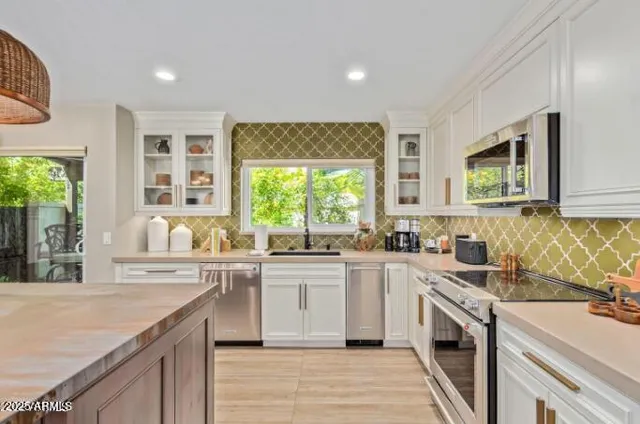 a kitchen with a sink stove and cabinets