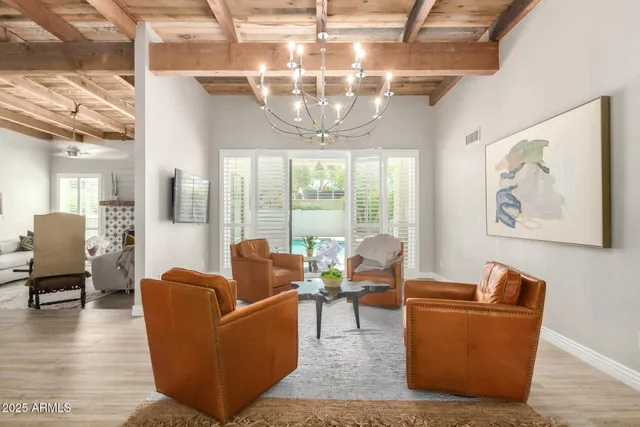a living room with furniture and a chandelier