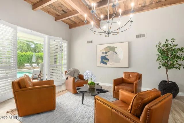 a living room with furniture a chandelier and a window