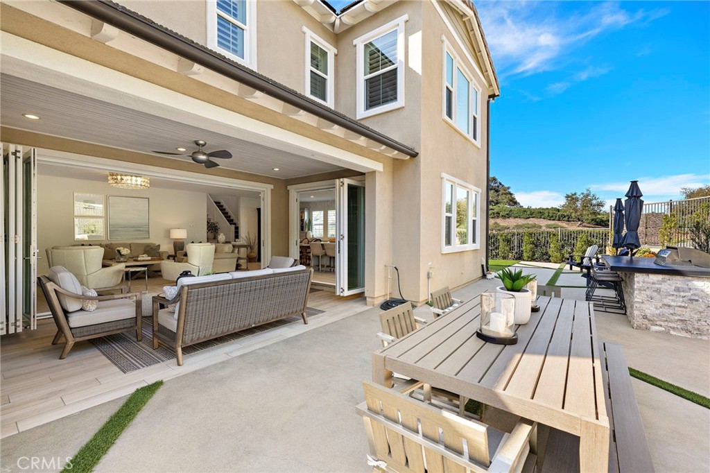 2 Ventada Street Rancho Mission Viejo, CA 92694 - Photo 19 of 71 a view of a patio with couches dining table and chairs with wooden floor