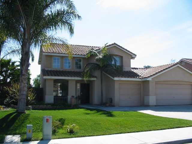 a front view of a house with a garden and yard
