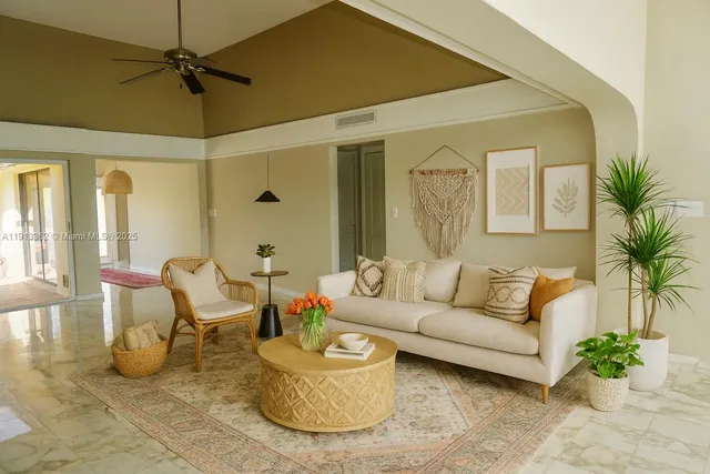 a living room with furniture and a potted plant