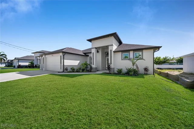 a front view of house with yard and green space