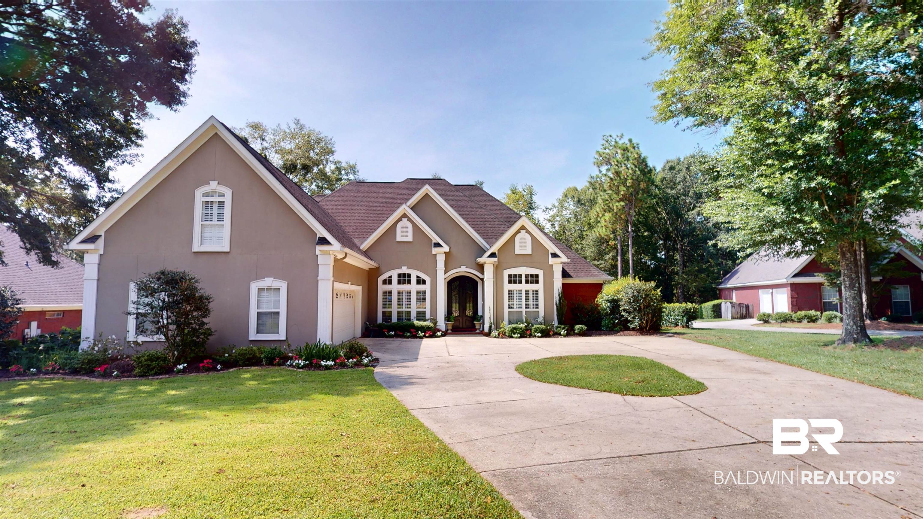 8775 Dawes Lake Road North Mobile, AL 36619 - Photo 1 of 59 Traditional-style house featuring stucco siding, driveway, a front yard, and a shingled roof