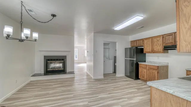 a kitchen with stainless steel appliances granite countertop a refrigerator sink and cabinets